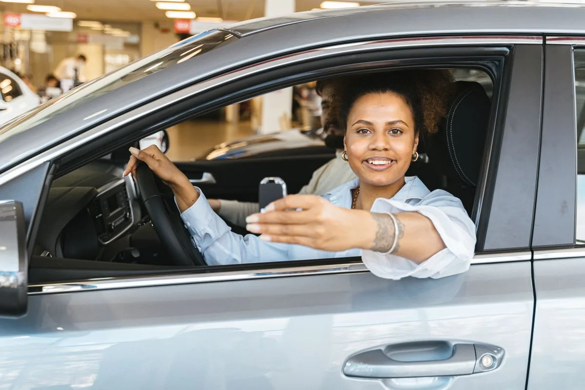 New driver holding her car key after booking and passing a road test in Windsor, Ontario